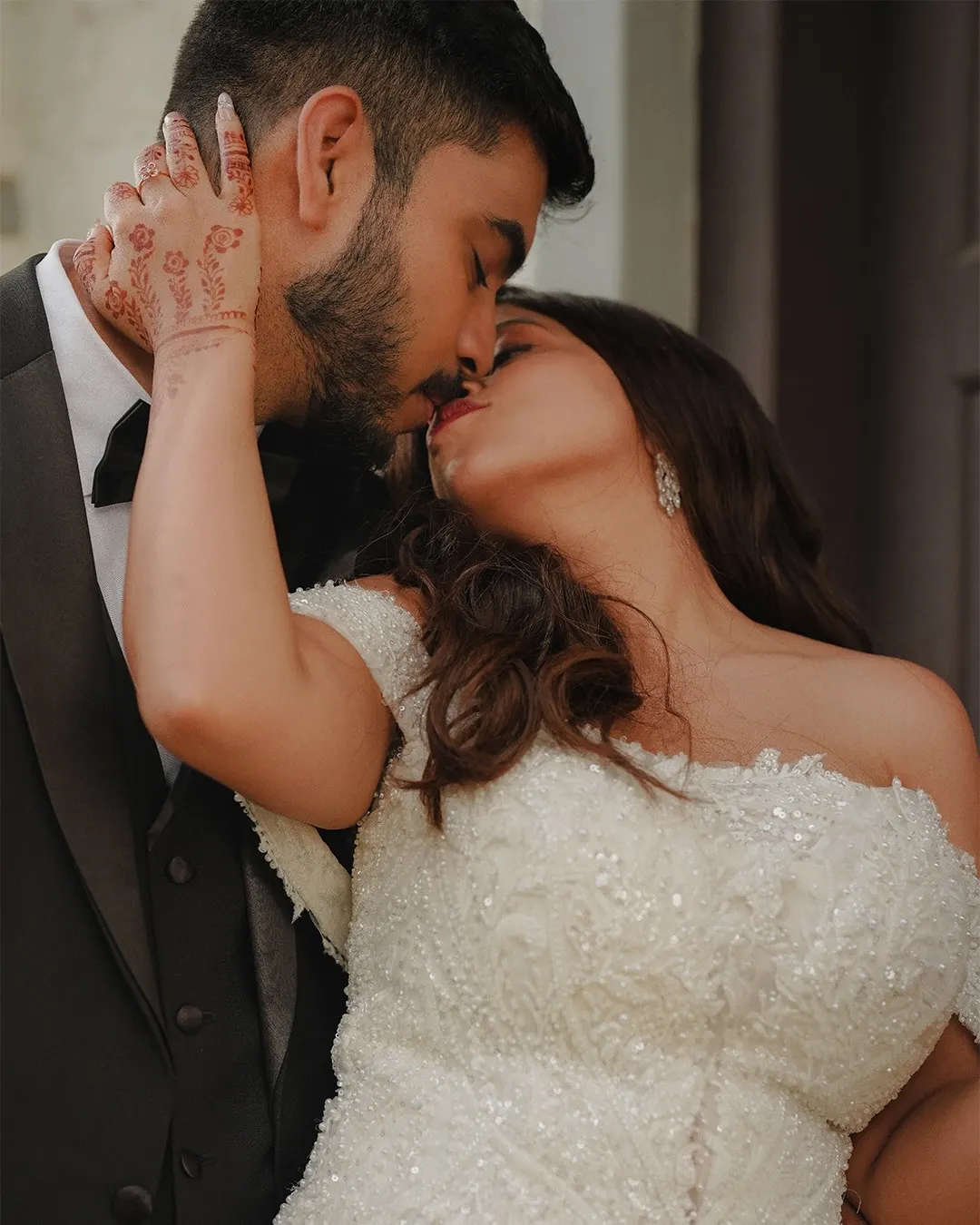 Bride and groom sharing a close wedding portrait