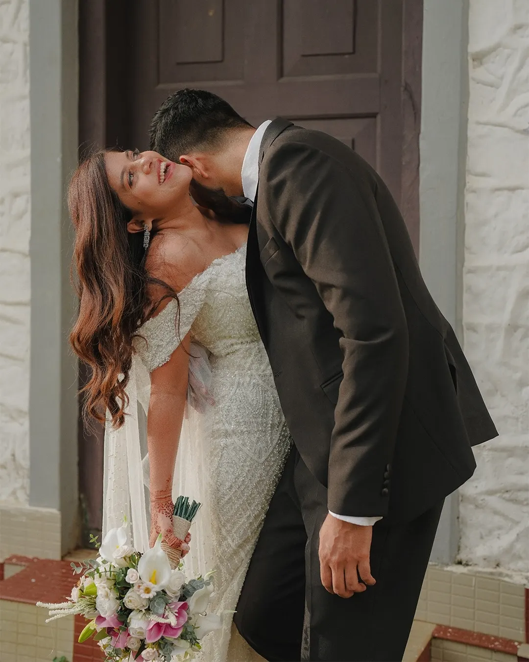 Newlyweds sharing a kiss after their ceremony