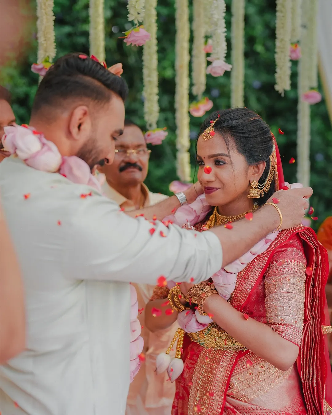 Groom placing a garland on the bride
